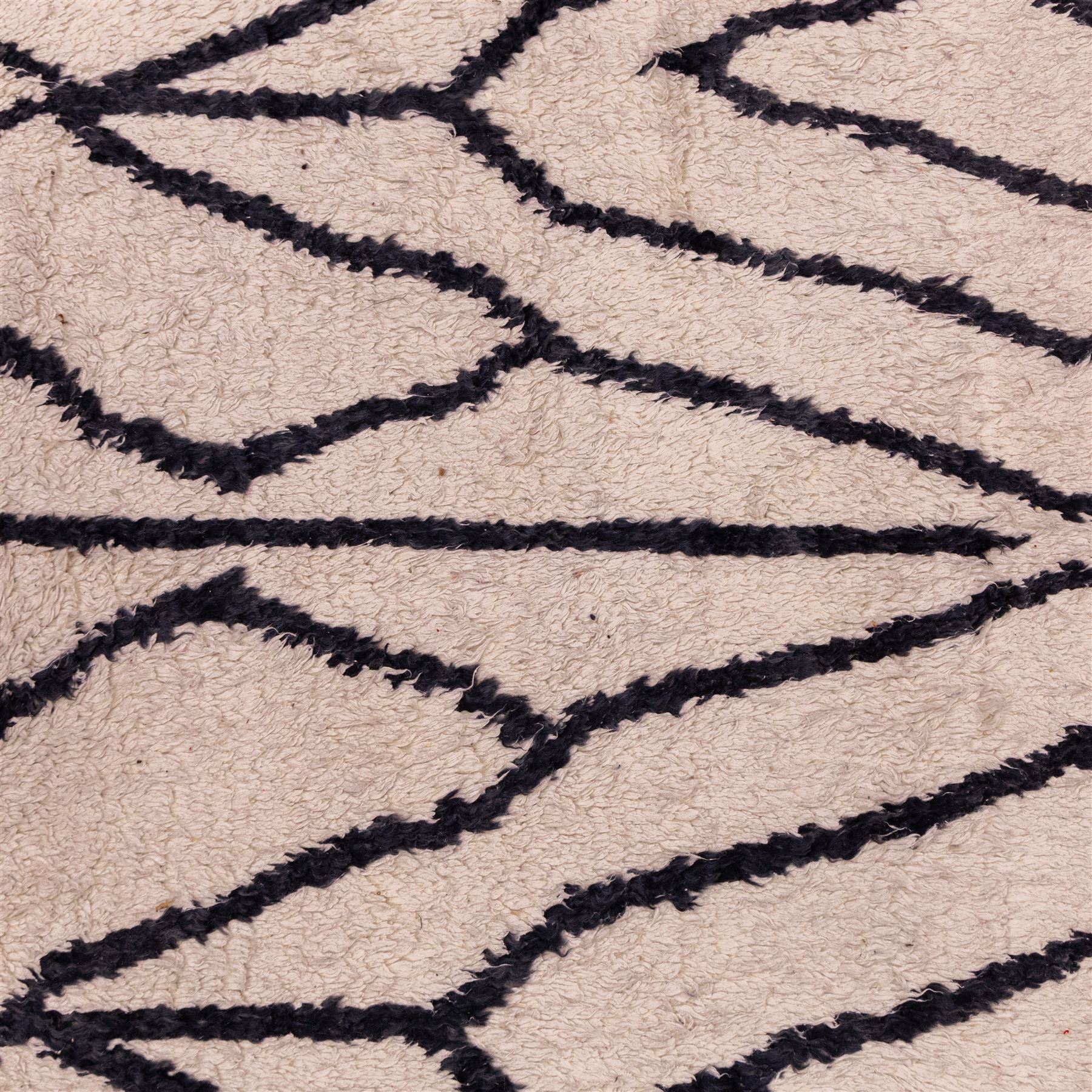 Moroccan Berber wool hand knotted rug, the cream ground decorated with abstract diamond forms and angular lines in dark brown, enclosed by a simple patterned border, with short fringe ends