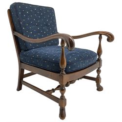 Early 20th century stained beech framed armchair, cane panel back over scrolled arm terminals, raised on turned supports united by turned H-stretcher, with patterned blue upholstered loose back and seat cushions