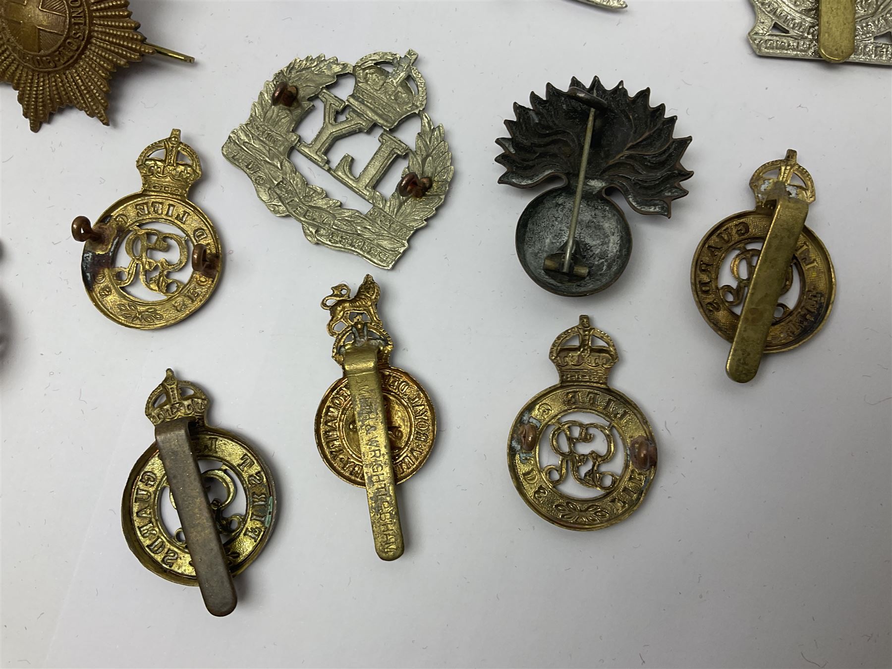 Twenty-six cap badges for Yeomanry and various guards including Fife & Forfar, Lothian and Border Horse, Leicestershire, Northamptonshire, Queens Own, Coldstream, Grenadier, Machine Gun Regiment, Life Guards etc (26)