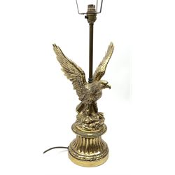 A brass table lamp modelled in the form of an eagle upon a circular base, overall H73cm.