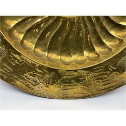 Arts and Crafts brass charger, the dished centre with fluted decoration in relief, surrounded by a continuous band of fish against a hammered ground to the rim, D59cm