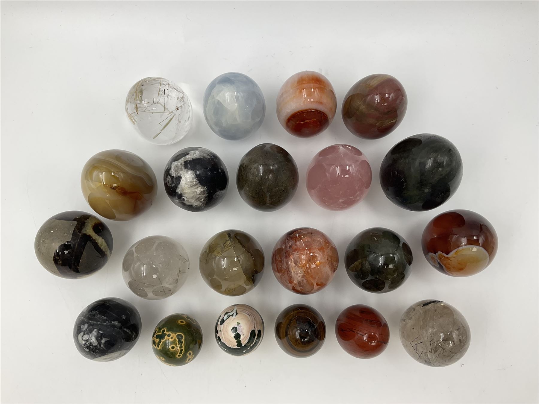 Collection of twenty-one hardstone specimen eggs, including labradorite, calcite, orbicular jasper, tiger's eye, smokey quartz, fossilised wood etc, originally part of the collection of the late Stanley J Seeger