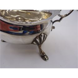 Pair of silver sauce boats, of typical plain form, with acanthus capped flying scroll handle and each upon three hoof feet, hallmarked Walker & Hall, Birmingham 1901, H9cm