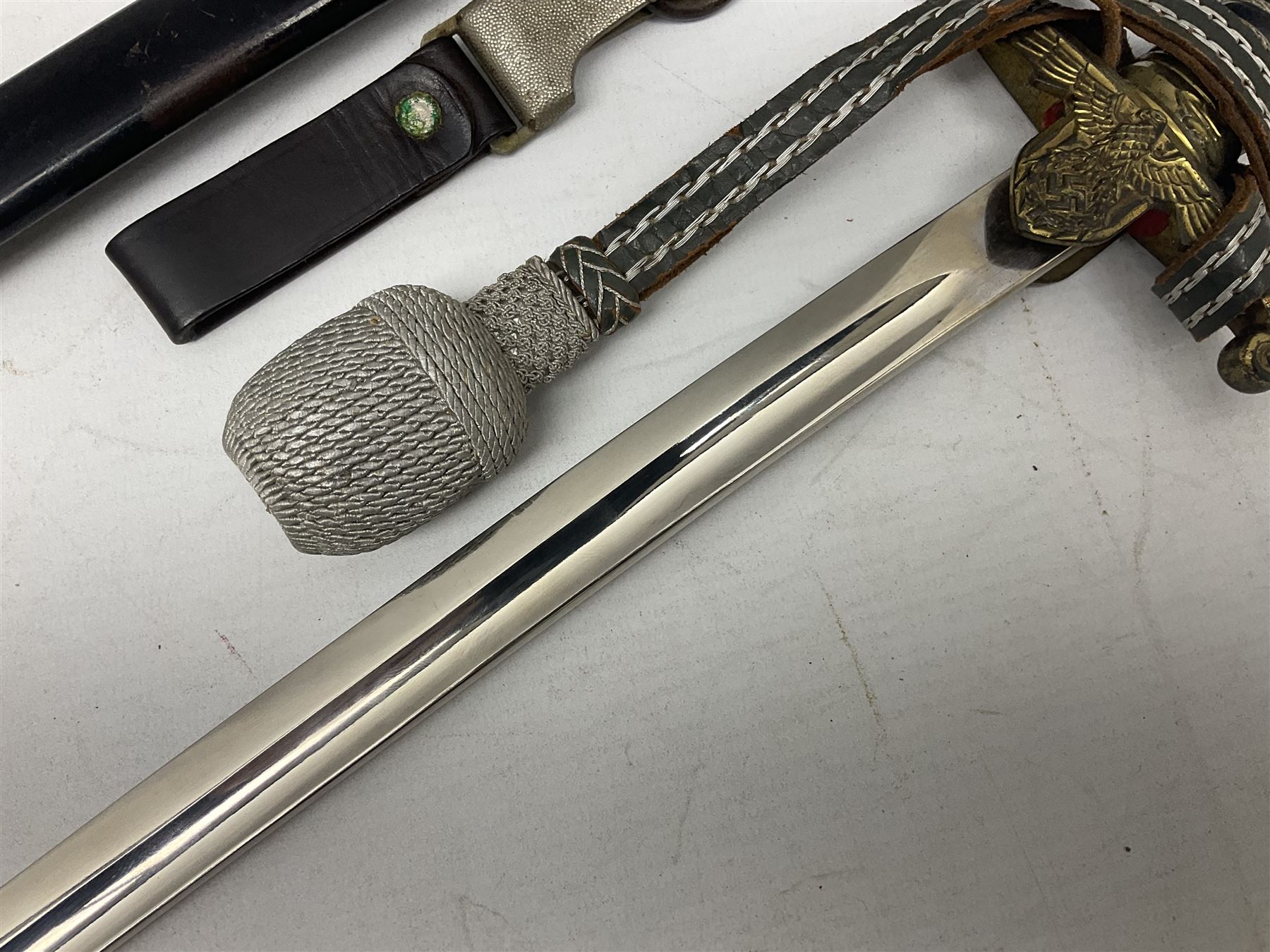 WW2 German Army Prinz Eugen Pattern Officers Dress Sword by Carl Eickhorn, the 80.5cm slightly curving fullered blade with makers name to the ricasso, gilt brass hilt with eagle to the cross-piece and relief of oakleaves to the ferrule, Prinz Eugen style down winged eagle to the pommel of the backstrap; grip retains the original wire binding; in original black painted scabbard with single hanging ring, leather hanger marked 'RZM M5/71 OLC' and silvered knot L97cm overall