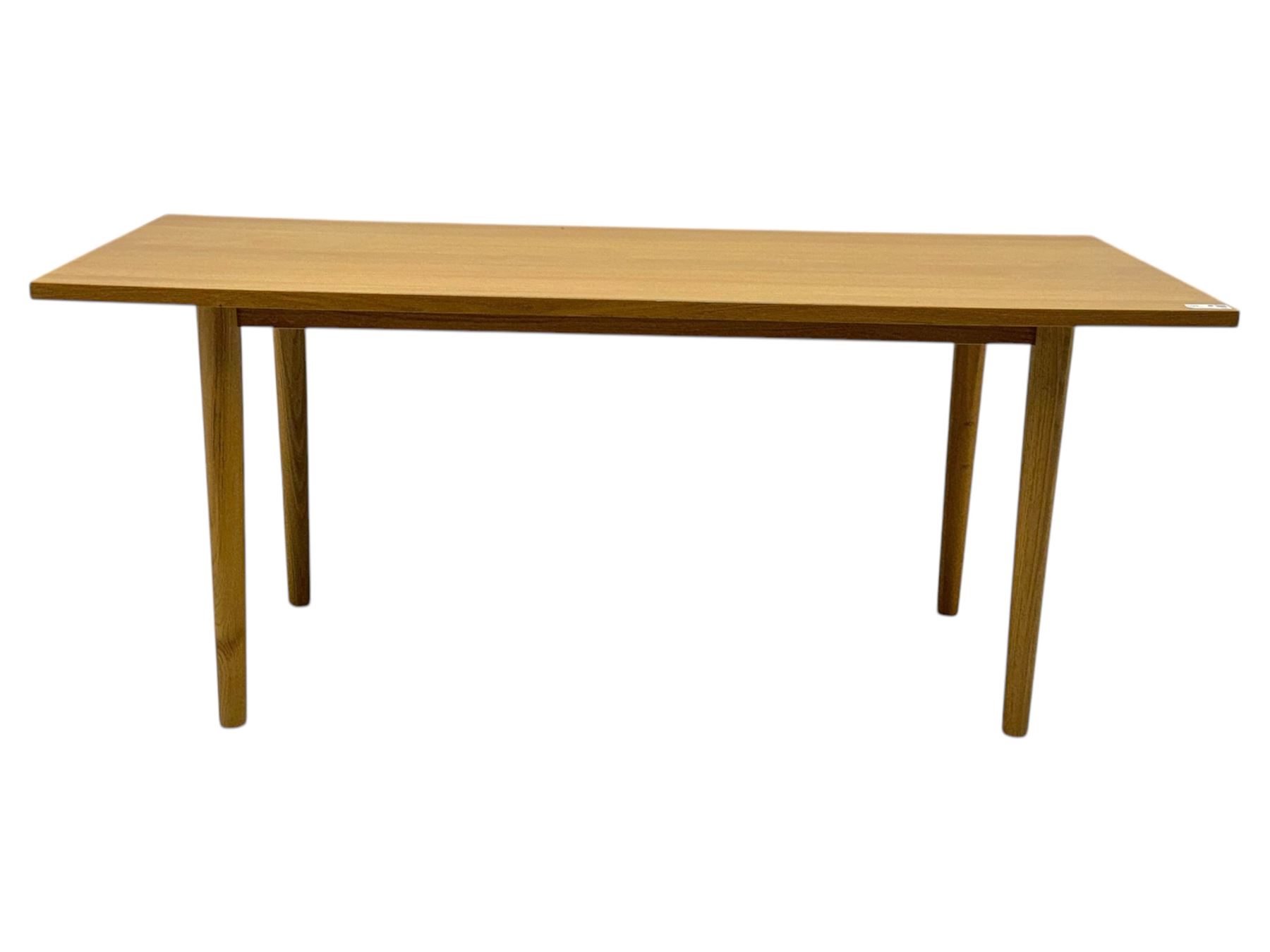 Ikea - Rectangular oak table, slim rectangular top over rounded edges, supported by tapered cylindrical legs  