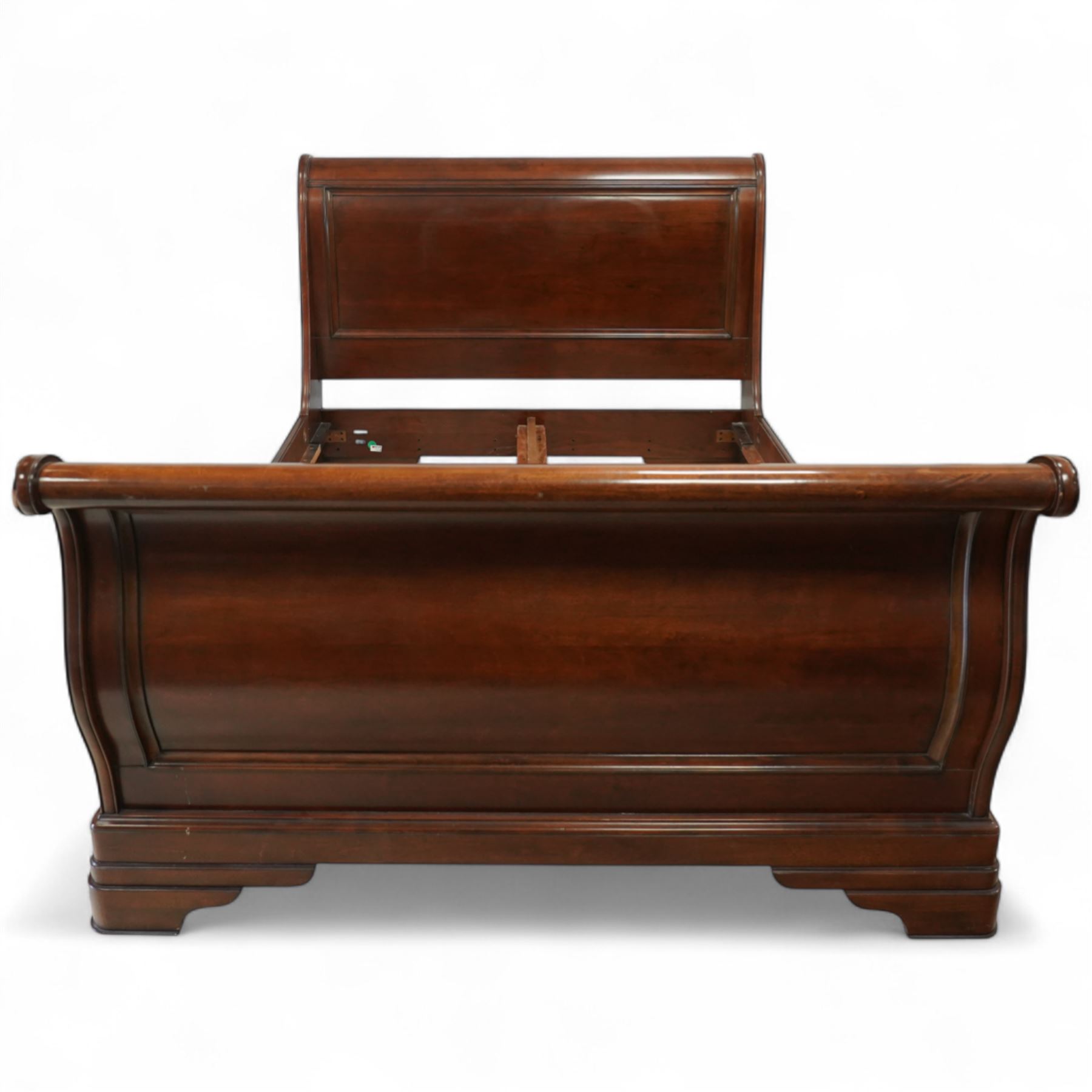 Late 20th-century mahogany Empire-style double sleigh bed, scrolled panelled headboard, and footboard, base with moulded plinth raised on bracket feet