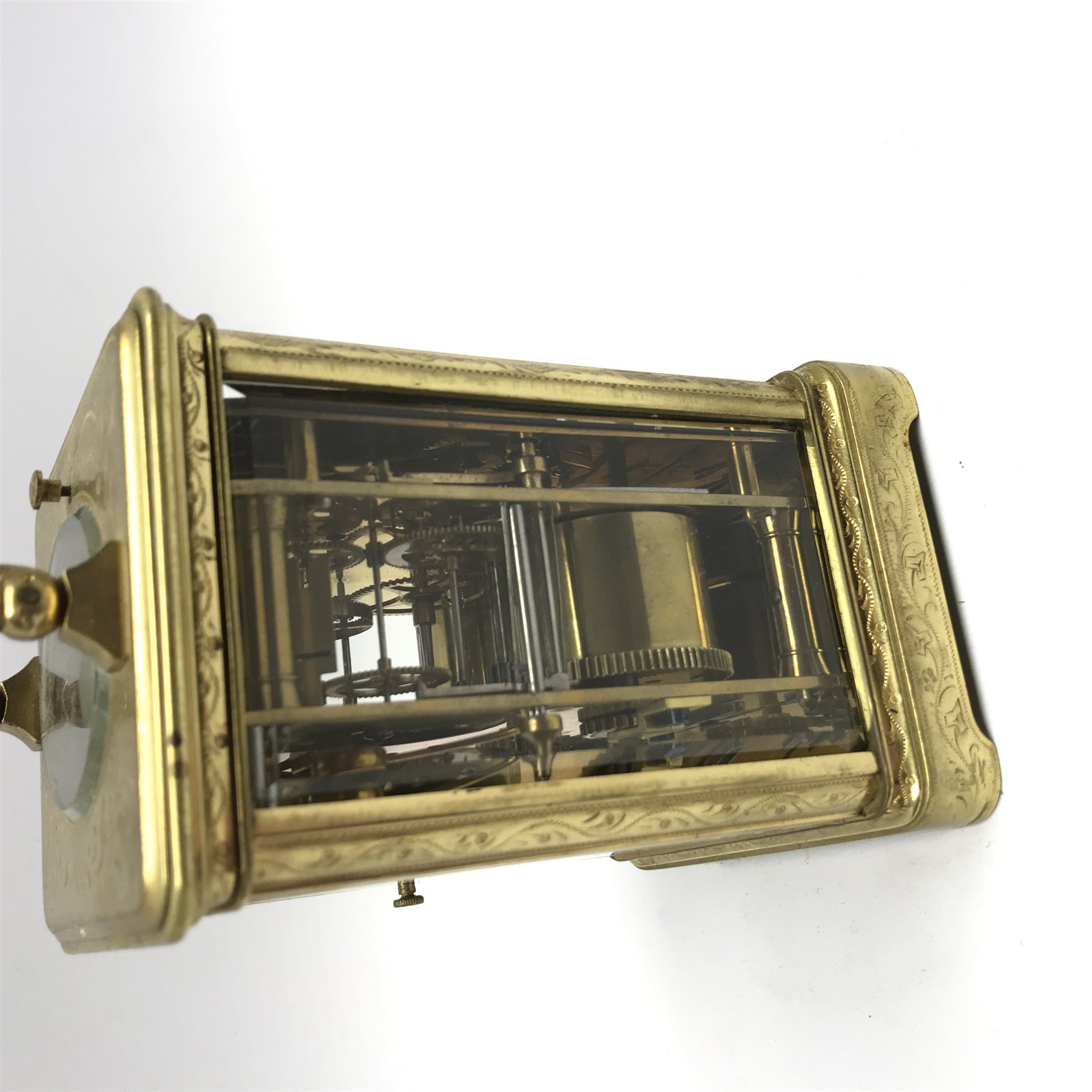 Early 20th century brass five glass carriage clock with button repeater, the brass case engraved with trailing foliage decoration, white enamel Roman dial, eight day movement striking the hours on bell, inscribed 'J. T. Ellsworth from... J. Blundel, Crosby Hall', with key, H14cm