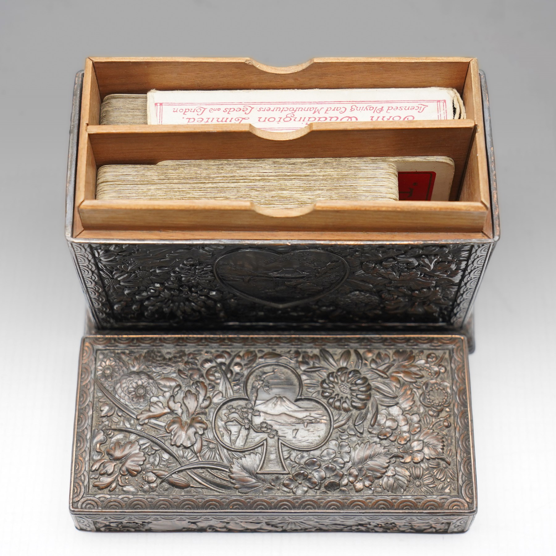 Japanese Meiji period bronze playing card box, decorated with intricate repoussé floral motifs, marked to base, W13cm H10cm