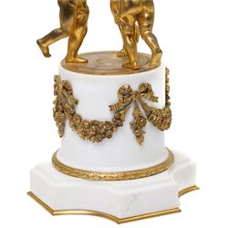 French- late 19th century 8-day globe clock, patinated globe with applied gilt Roman numerals, arrow-shaped hands and supported by three ormolu putti on a stepped columnar white marble base with a floral garland mount, twin train Parisian movement by Japy Freres with a recoil anchor escapement and countwheel strike, sounding the hours and half-hours on a bell. With pendulum.