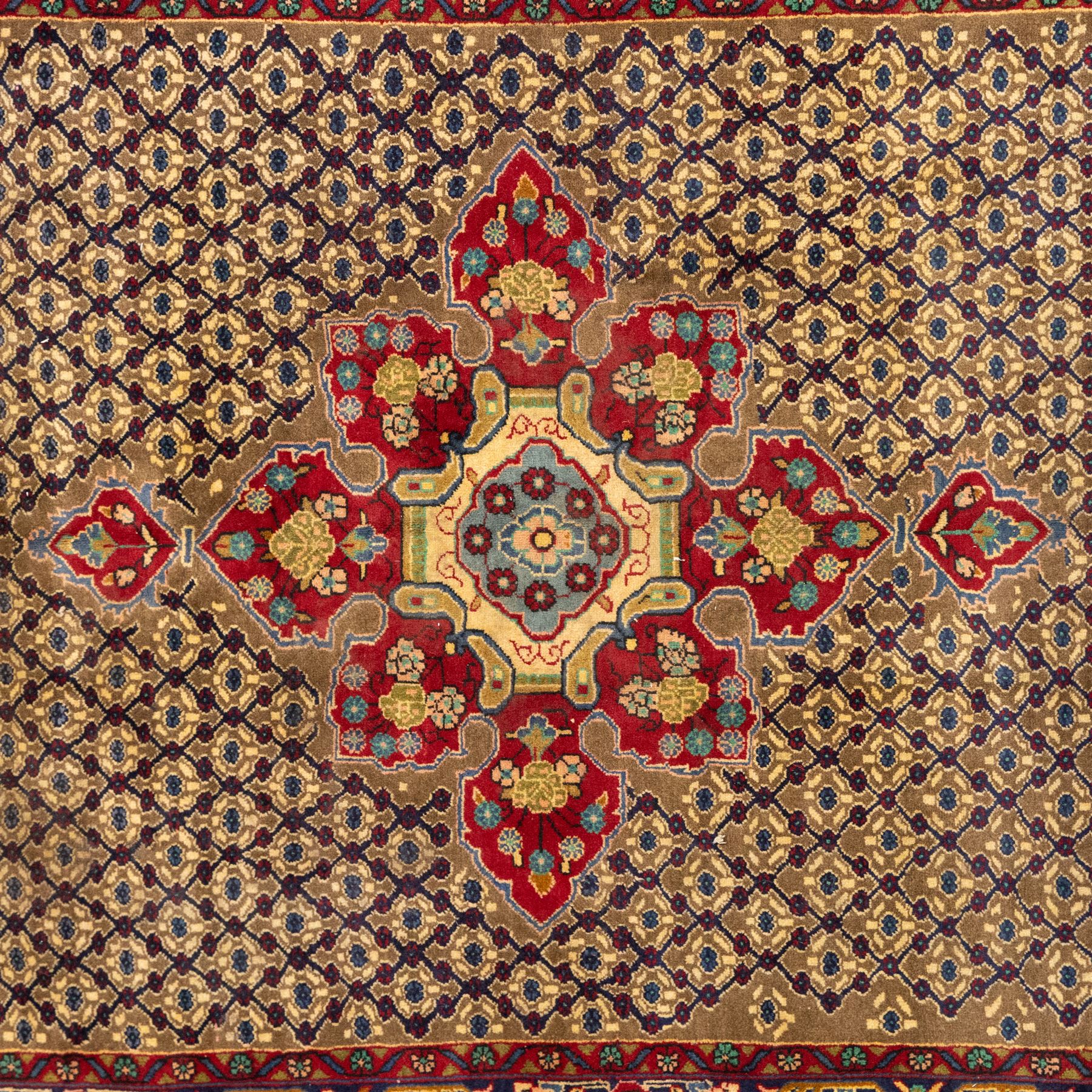 South West Persian Bidjar hand-knotted rug, olive and camel-toned field decorated with an all-over Herati lattice design with a central floral medallion within a wide floral border with shaped floral spandrels and multiple guard borders in tones of navy, ivory, crimson, and green, with cotton fringe ends  