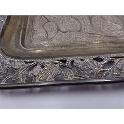 Silver twin handled tray, probably Indian, of rectangular form the centre with vacant rectangular panel within a stylised foliate chased surround and foliate pierced rim, including handles L38cm, approximate weight 14.29 ozt (444.5 grams)