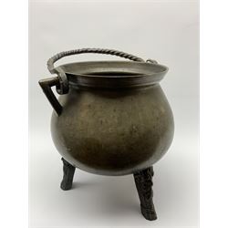 17th century bronze cauldron, probably German or Austrian, of bellied form with twin angular handles supporting a twisted handle, upon three splayed zoomorphic bearded mask feet, not including handle H30cm, rim D22cm
