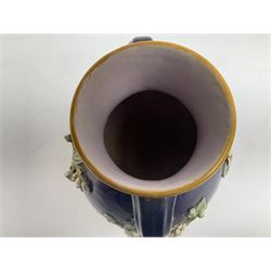 Minton majolica vase, the squat body with twin handles, with part osier moulding and applied Spring flowers against a cobalt blue ground, upon integral square base, impressed beneath Minton 1316, H16.5cm