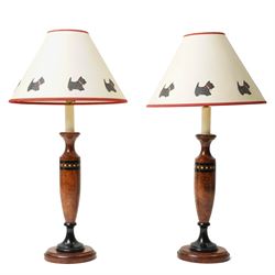 Pair of walnut scumbled pine table lamps, the cream shades with a band of stencilled Scott...