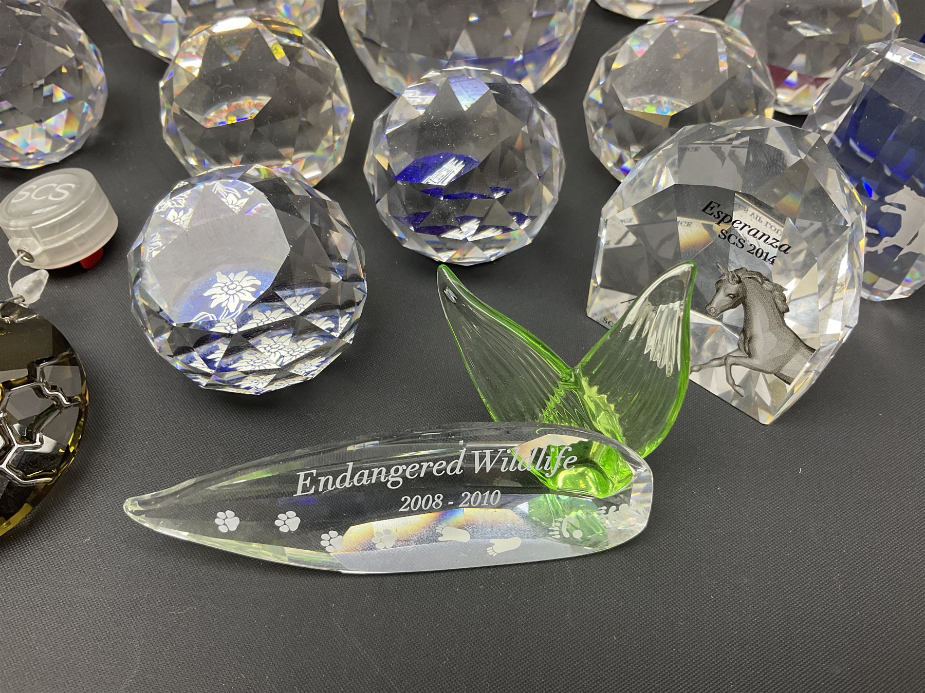 Swarovski Crystal paperweights, to include a globe with dove to the top, pyramid shapes etc, together with a large collection of boxes and stands  