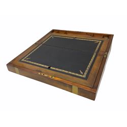 Victorian brass bound walnut writing slope, with brass escutcheon and vacant brass panel to the hinged cover, opening to reveal a gilt tooled black leather slope, and pen tray flanked by two glass inkwells, H17.5cm L50.5cm D25.5cm. 