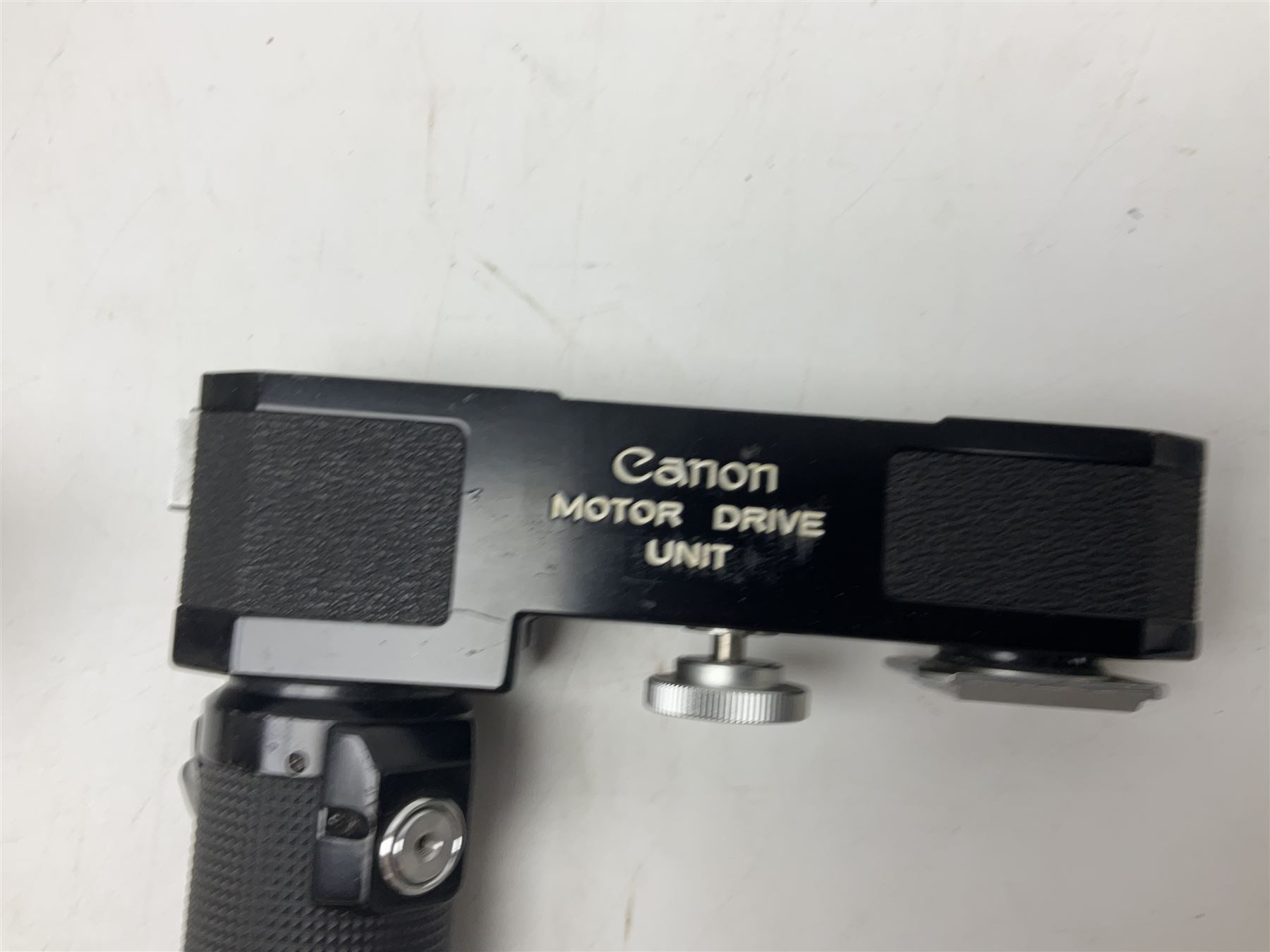 Collection of Canon lenses, to include 'Canon Lens FD 100mm 1:2.8', serial no 12821, 'Canon Lens FD 200mm 1:4' serial no 245313, 'Macro Canon Lens FL 50mm 1:3.5', serial no. 25505, 'Canon Lens FD 135mm 1:3.5 etc, together with other Canon equipment, including Bellows FL, Slide Duplicator etc 