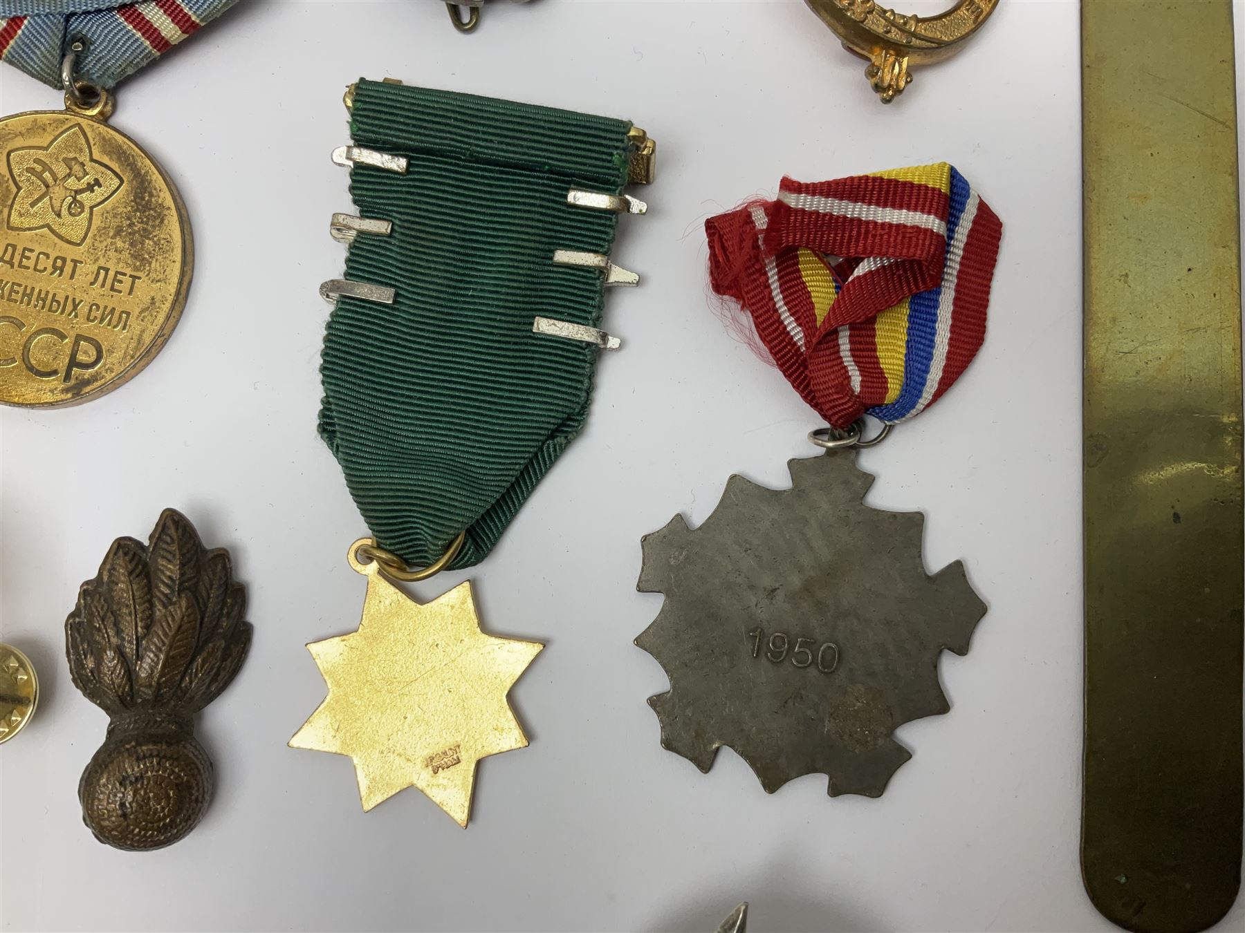 Collection of approximately sixty worldwide medals, metal badges, belt buckles, cloth badges, trench art, brass button stick etc