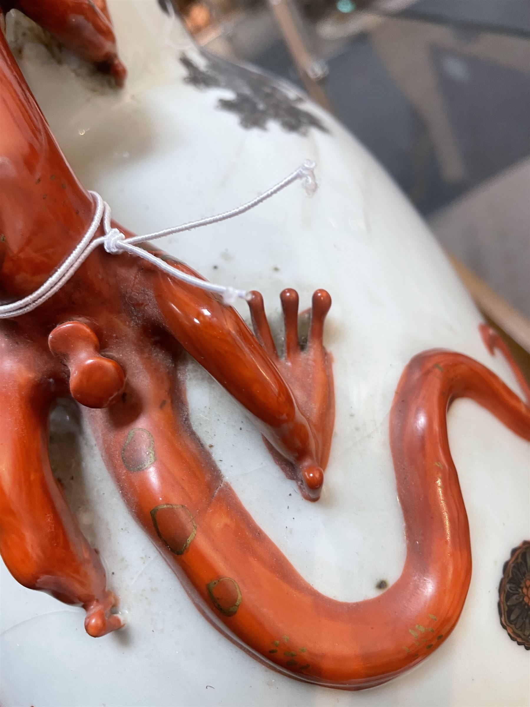 Chinese Republic period porcelain moon flask vase, of typical compressed spherical form, the neck and shoulders with applied iron red dragon handles, the body decorated in iron-red and grisaille with a 'one hundred children' design, depicting various children at play and engaged in musical pursuits within a garden setting, with apocryphal Qianlong mark beneath, H47cm