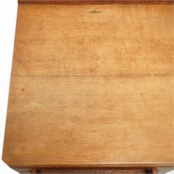 Rabbitman - oak single pedestal desk, adzed top with galleried back, with three graduating drawers with turned wooden knobs, enclosed kneehole with adzed detailing throughout the panelling and supports, with carved rabbit signature, by Peter Heap of Wetwang