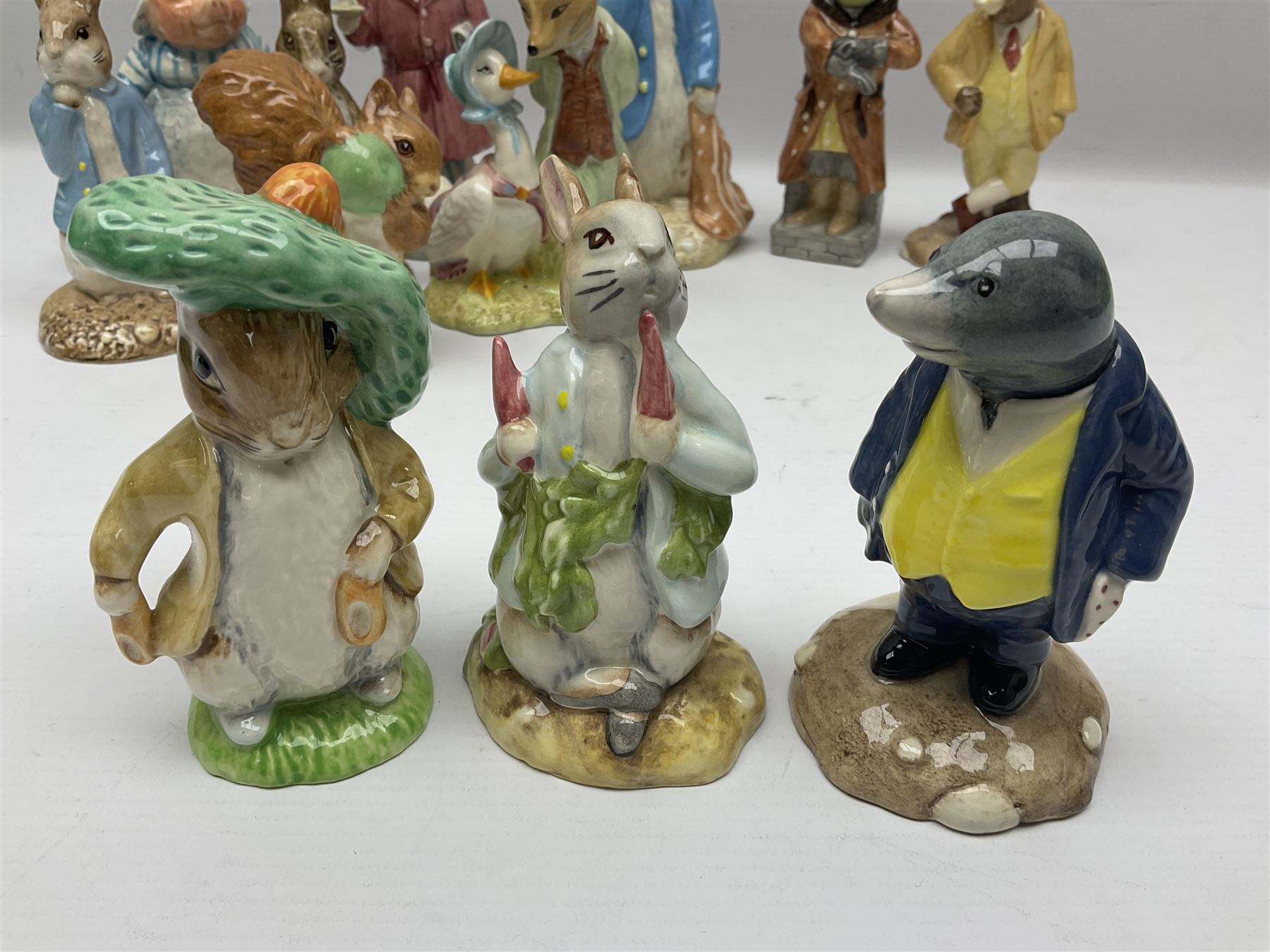 Sixteen Royal Albert Beatrix Potter figures, including Poorly Peter Rabbit, Jemima Puddle Duck and Squirrel Nutkin etc, all boxed together with a Beswick Beatrix Potter Jeremy Fisher miniature jug and four Beswick Wind in the Willows figures 