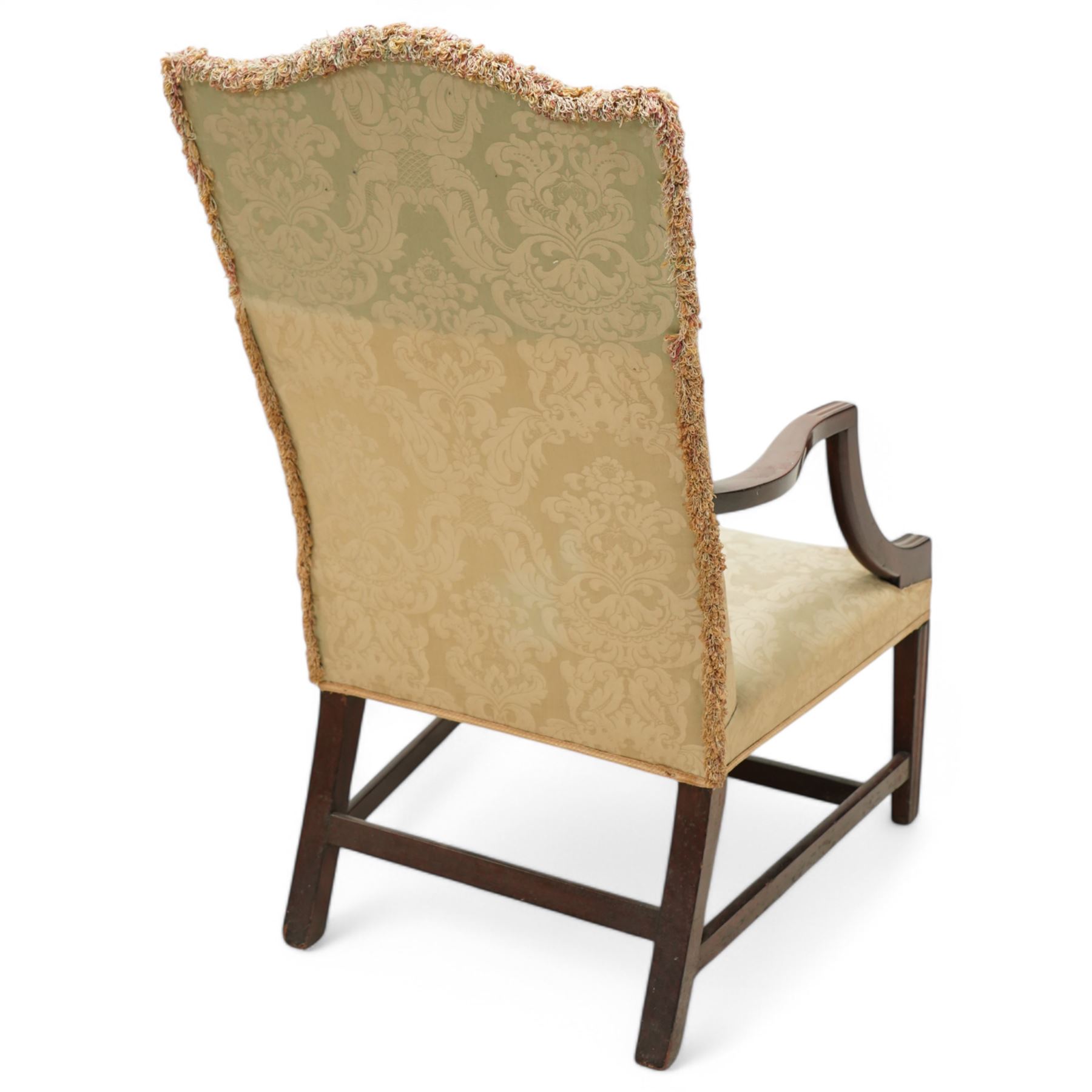 Georgian design mahogany framed Gainsborough armchair, arched cresting rail over shaped arms on curved and moulded supports, upholstered in pale green fabric with repeating foliate pattern, on square tapering moulded supports united by plain stretchers 