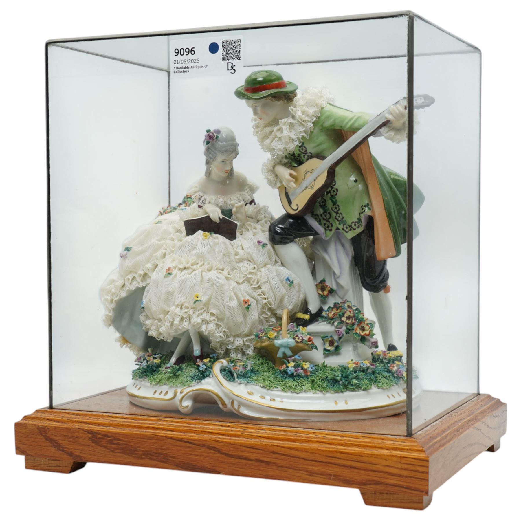 Unterweissbach style porcelain figural group of a seated lady with a gentleman playing a lute, stamped 'Foreign' to base, in bespoke display case