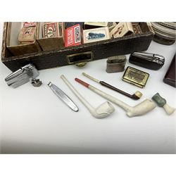 Smoking related items, including table lighters, two wooden pipes, two clay pipes, and  matchboxes.  