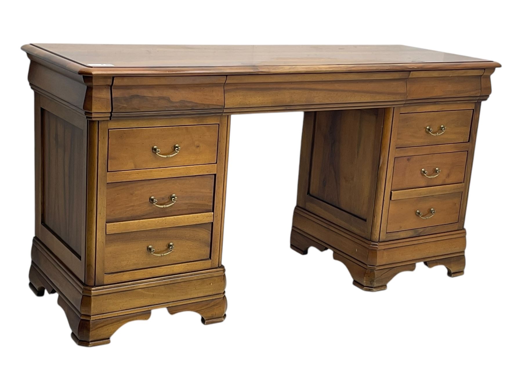 French cherry wood kneehole desk or dressing table, moulded rectangular top over twin pedestal bases each housing three drawers with brass-effect swing handles, resting on bracket feet