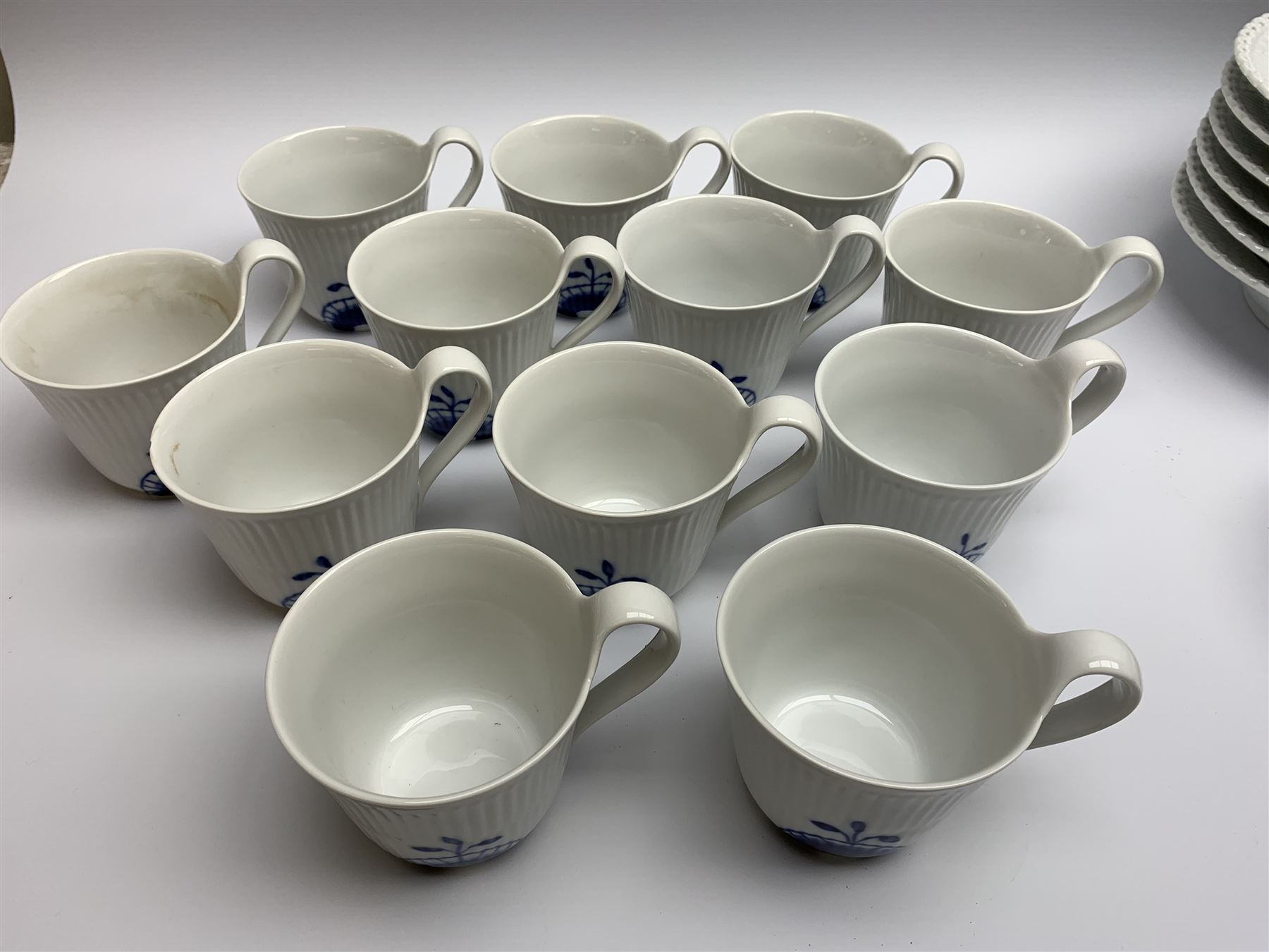 Royal Copenhagen tea and dinner service for twelve place settings, decorated in the Mega Blue Fluted pattern, pattern number 622, comprising dinner plates, salad plates, bowls with pierced rim, smaller bowls, tea cups, and saucers, dinner plates D27.5cm, salad plates D22cm