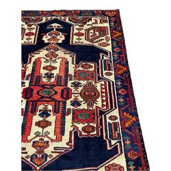 North West Persian Heriz rug, blue and ivory ground, decorated with stylised plant motifs, the border decorated with repeating geometric design 