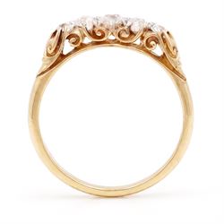 Early 20th century gold diamond ring, set with five graduating old cut diamonds, with scroll design gallery, stamped 18ct, total diamond weight approx 0.30 carat