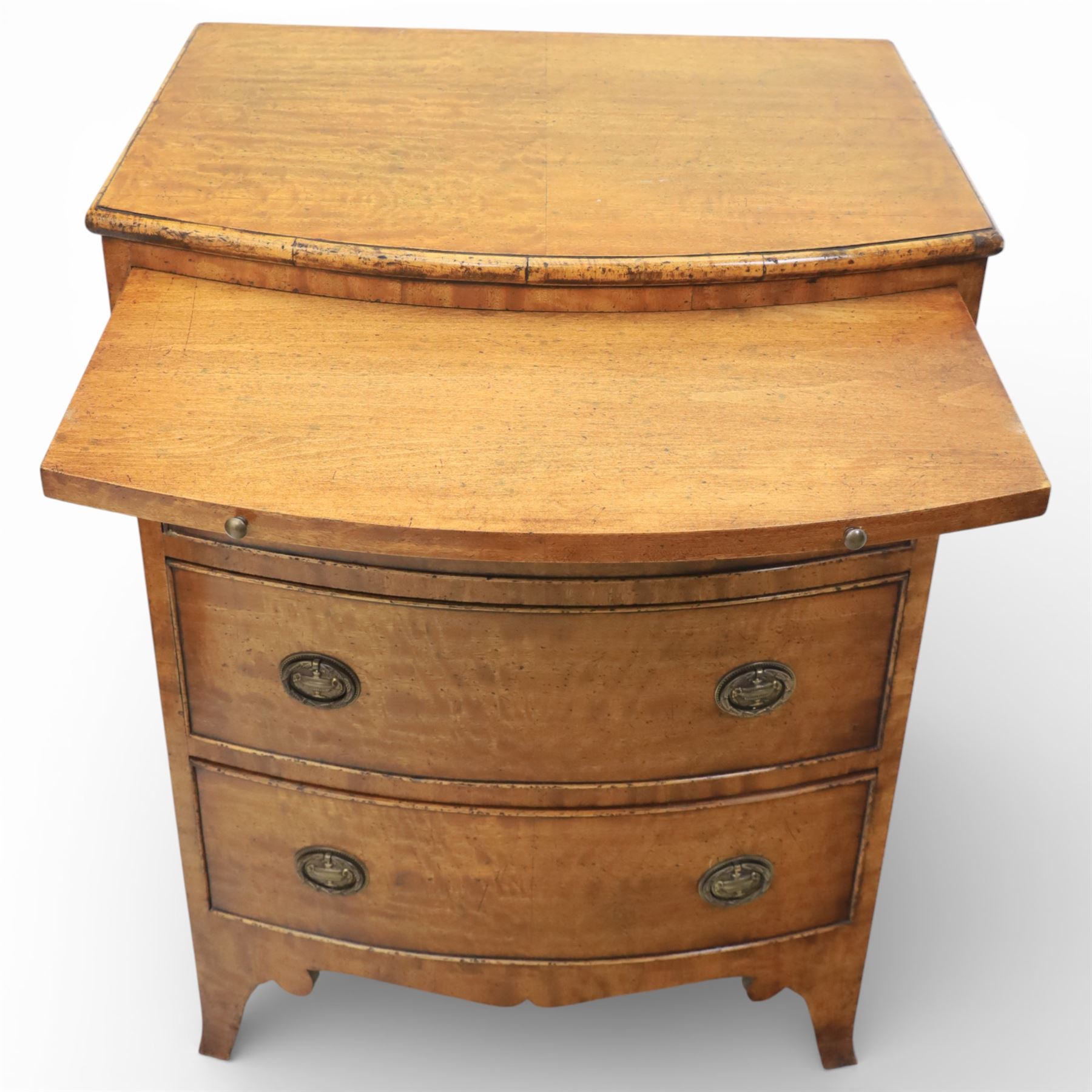 Georgian design bow front chest in figured walnut veneers, with moulded top over a pull-out brushing slide and three long drawers fitted with oval brass drop handles, raised upon swept bracket feet