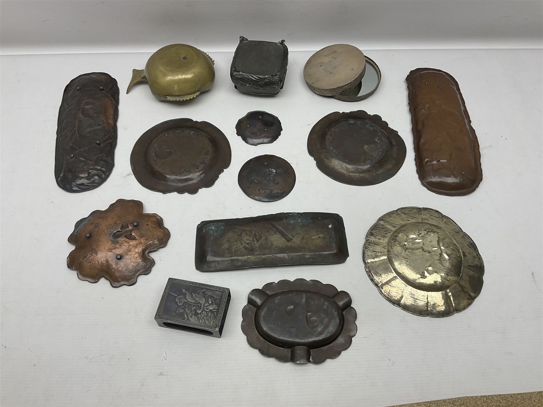 Brass sunfish ashtray, Chinese silver plated trinket box with mirror, bronzed matchbox cover and a collection of other Oriental bronzed embossed metal trays