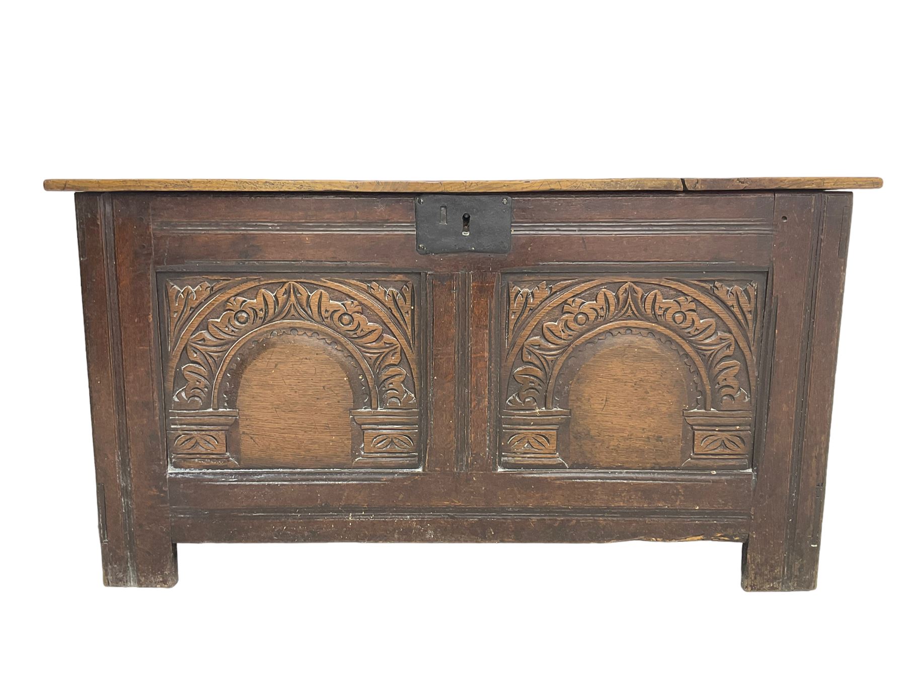 Jacobean Revival - 19th century oak blanket chest, rectangular hinged top, the two front panels carved arched foliate decoration, raised on stile supports