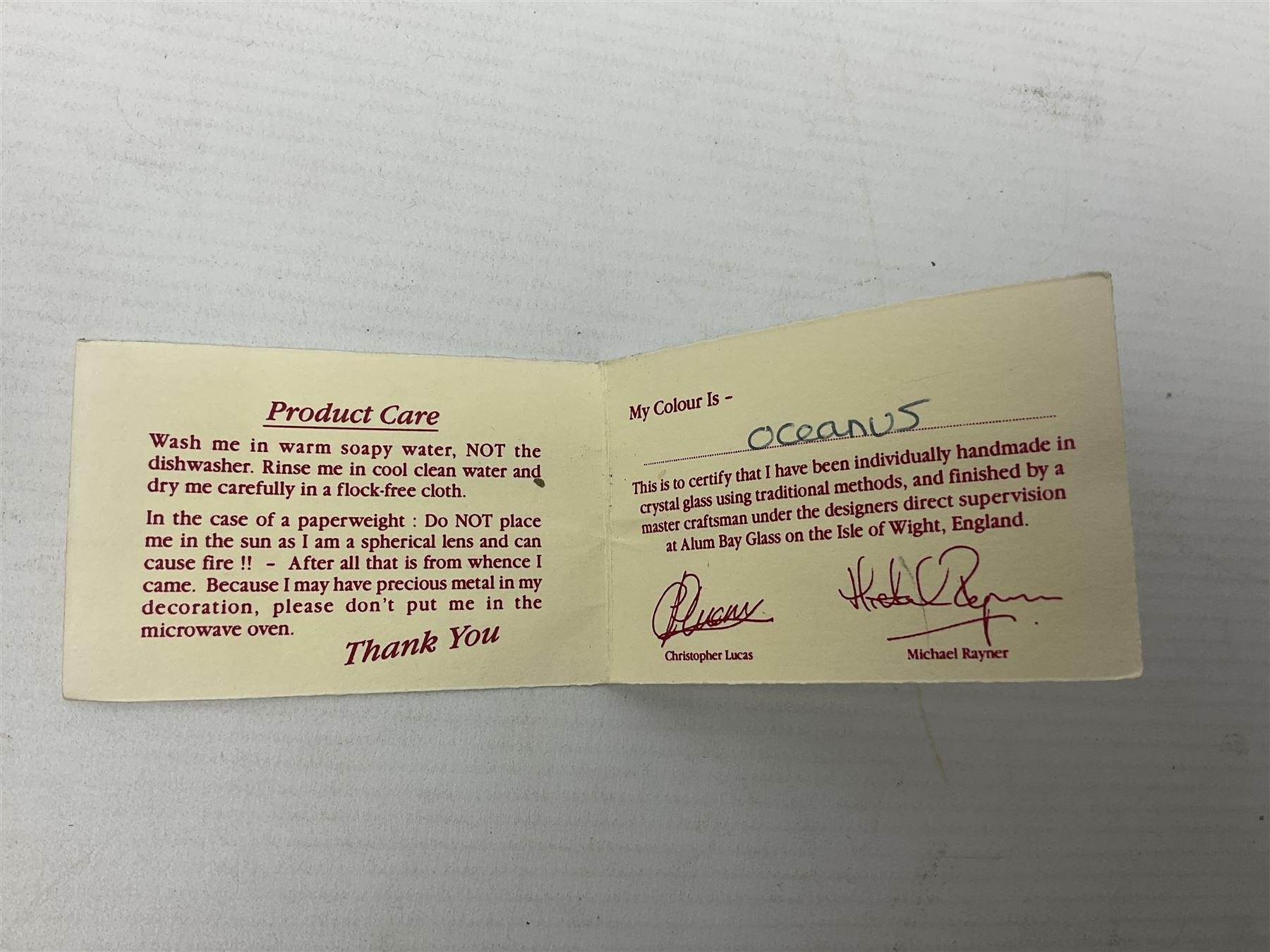 Two Isle of White glass vases, by Alum Bay Glass, both with blue swirl design upon an iridescent mottled blue/green ground, together with a Gozo Glass vase of pebble form, with similar design, H12cm