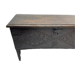 Small 17th century six plank coffer or chest, the moulded rectangular hinged top with wrought iron lock and fittings, the front and sides carved with concentric lozenges and stylised floral decoration, with vertical carved rails