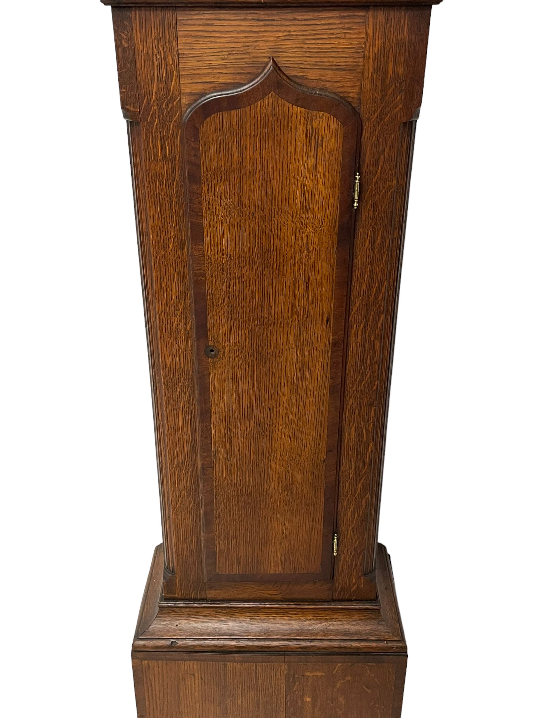 John Greaves of Newcastle - Mid-18th century 8-day oak longcase clock with a flat top, double cornice and break arch hood door flanked by two turned pilasters, trunk with canted corners and a spire topped door with crossbanding, rectangular plinth raised on bracket feet, brass dial with cast spandrels and penny-moon dial and pointer to the arch, matted dial centre with a silvered chapter ring and seconds ring, chapter with Roman numerals, five minute Arabic's, minute and quarter tracks, square date aperture and fettled steel hands, dial pinned to a rack striking movement with a recoil anchor escapement. With pendulum and weights.
