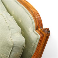 French Empire design varnished wood three piece lounge suite comprising of two cane armchairs and matching sofa, carved top rails with foliate terminals, cane side panels and padded scroll arms, upholstered in a green brocade with matching piping, on fluted legs