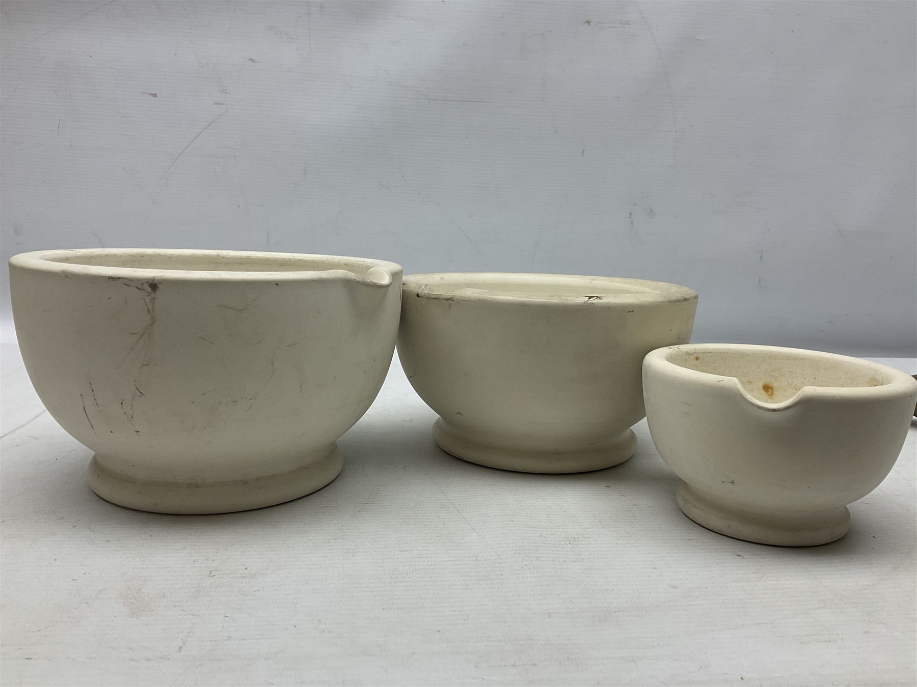 Group of pestle and mortars to include heavy bronze example with twin