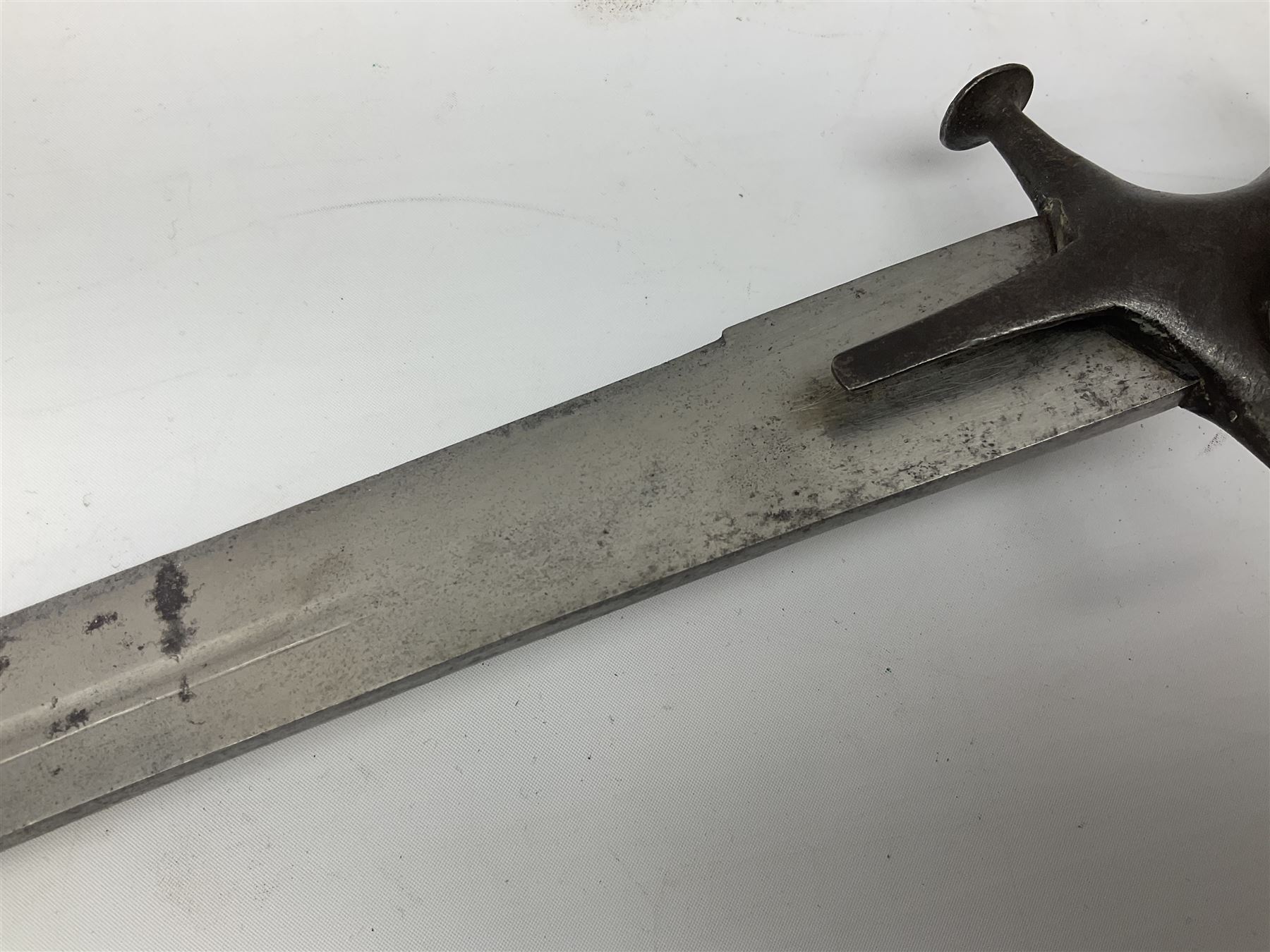 19th Century Indian Tulwar sword with 77cm single edged, slightly curved fullered blade;  steel crossguard, langets, grip and spiked disc pommel with stiff leaf decoration L90cm overall