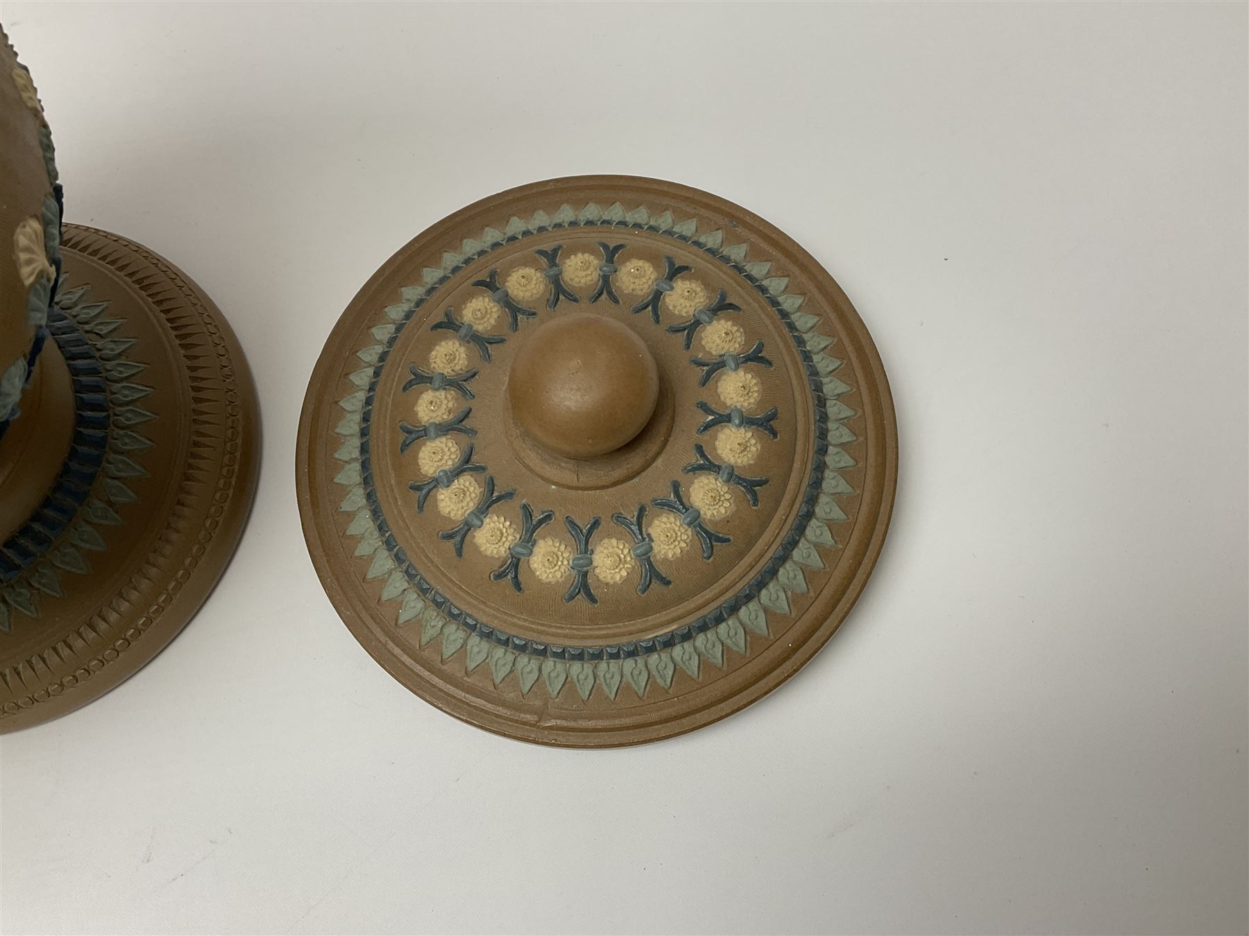 A late 19th century Doulton Lambeth stoneware water filter with original spigot, decorated with relief moulded foliate bands, with impressed marks and monogrammed for Laura Gooderham beneath, H34cm. 