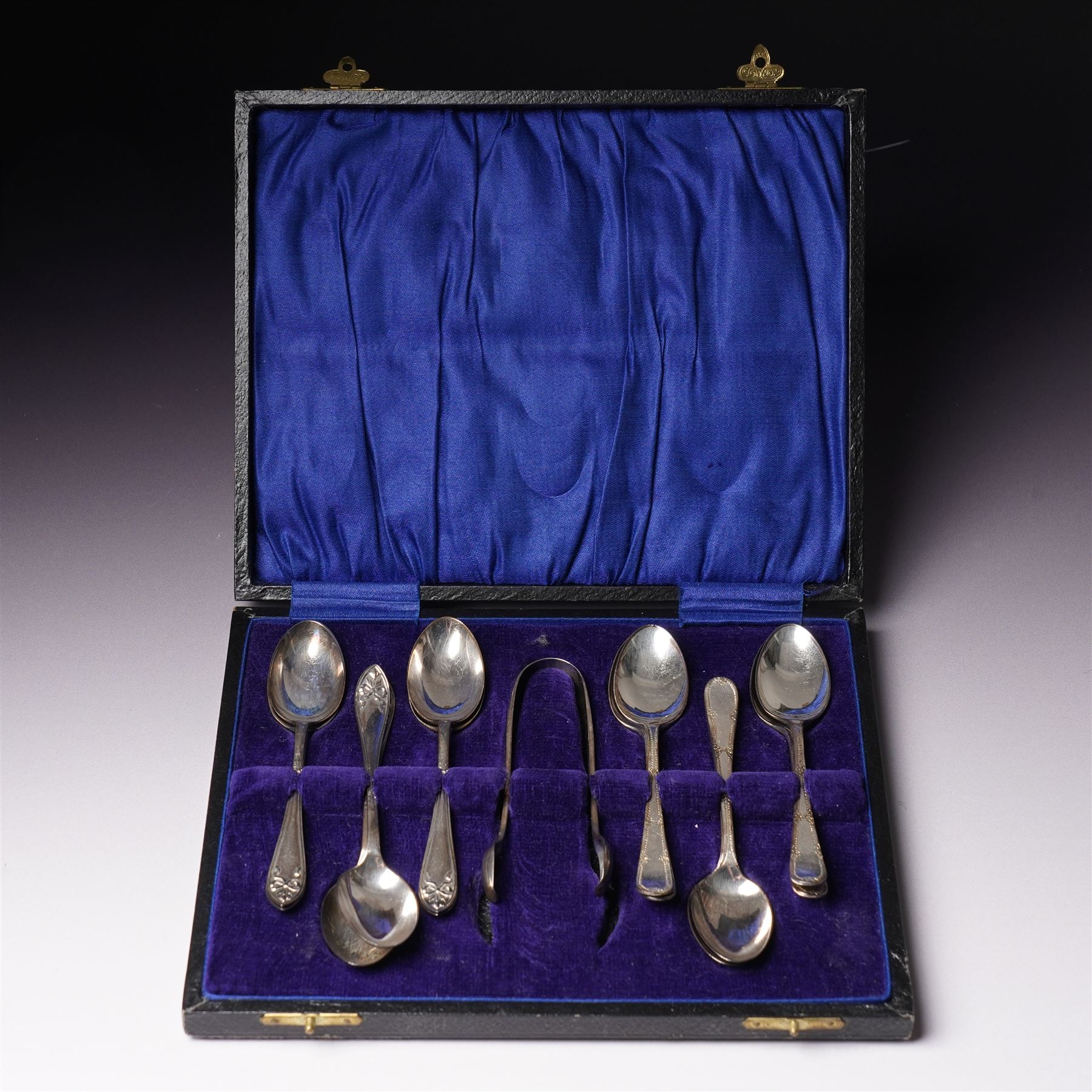 Set of  of six silver coffee spoons and tongs with bright cut decoration Sheffield 1908 Maker Cooper Bros. and another set of six coffee spoons with decorative terminals