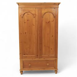Two contemporary traditional-style wardrobes, projecting plain cornice above two arched moulded panel doors, above a full-width drawer fitted with turned wooden handles, raised on turned bun feet