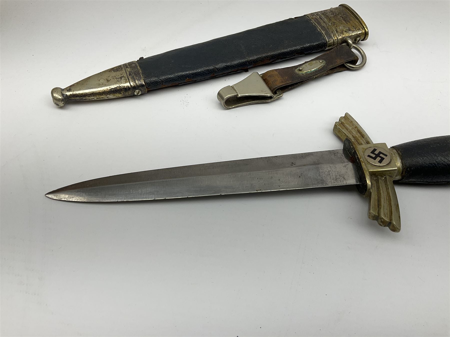  WW2 German SMF Solingen DLV flyers dagger with 16cm steel blade, nickel downswept cross-piece and pommel and leather covered grip, in leather and nickel scabbard with leather suspension strap L34cm overall. After WWI Germany was forbidden an air force by the Treaty of Versailles however the Deutscher Luftsport-Verband (German Air-sport Association) was formed in March 1933 from various sports flying clubs and had branches for aeroplane, gliding and balloon flying. Under cover of the sporting DLV, many future Luftwaffe pilots trained to fly. DLV was embodied with the NSKK in March 1935 and 1st March 1937 Luftwaffe formed.