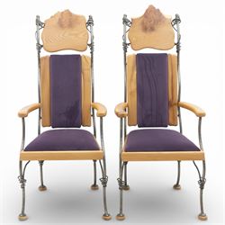 Paul Hodgkiss Designs of Glasgow - contemporary shaped elm dining table with wrought iron base; with set ten (8+2) matching high-back dining chairs, table of organic form above an elaborate wrought iron supports, with central elm stretcher, the chairs with en suite with matching wrought iron work burred elm headrest, purple velour upholstery with drop in seat     

Table: W 102cm, L 243cm, H 74cm
Chairs: W 56cm, D 52cm, H 130cm