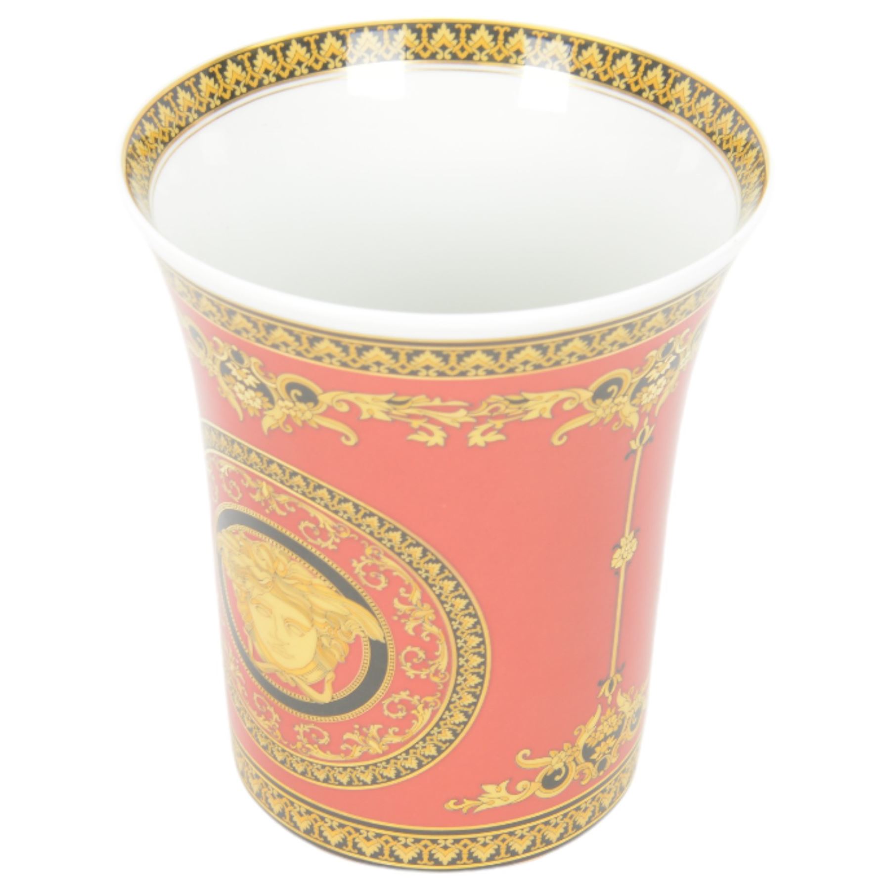Rosenthal Medusa Versace vase, featuring a gold-shaded Medusa head surrounded by baroque details upon a red ground, H18cm 