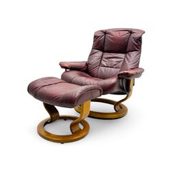 Ekornes Stressless, swivel armchair upholstered in red leather, with matching footstool su...