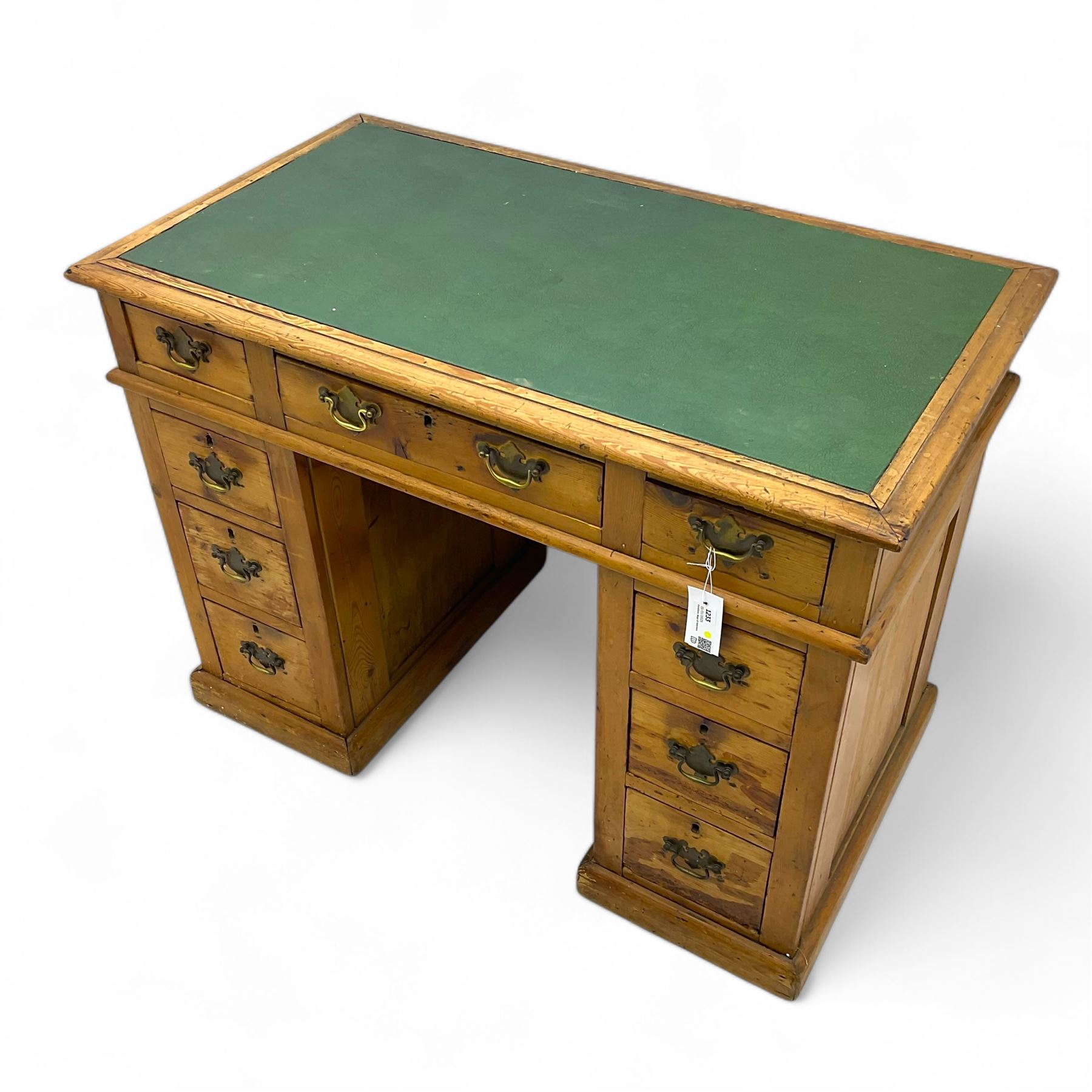 Rustic pine twin pedestal desk, rectangular green leather inset top above a central frieze drawer flanked by two short drawers, each pedestal featuring three graduated drawers, raised on a plinth base