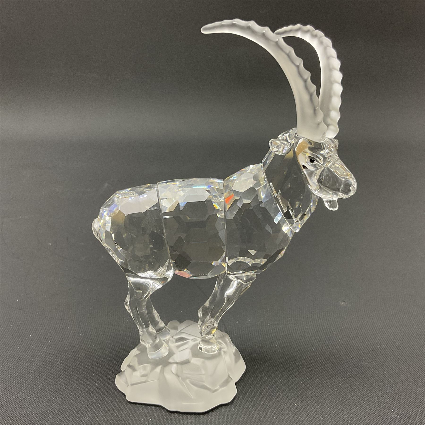 Swarovski Crystal animals, comprising white peacock, the tail with cascading blue flowers, perched eagle with yellow beak, ibex with frosted crystal horns and unicorn with frosted crystal horn, tallest H13cm